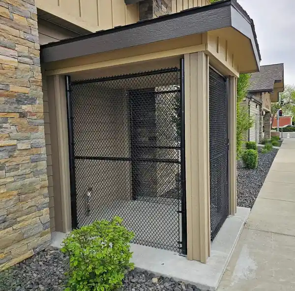 Black chain link cage enclosure built into an apartment entry